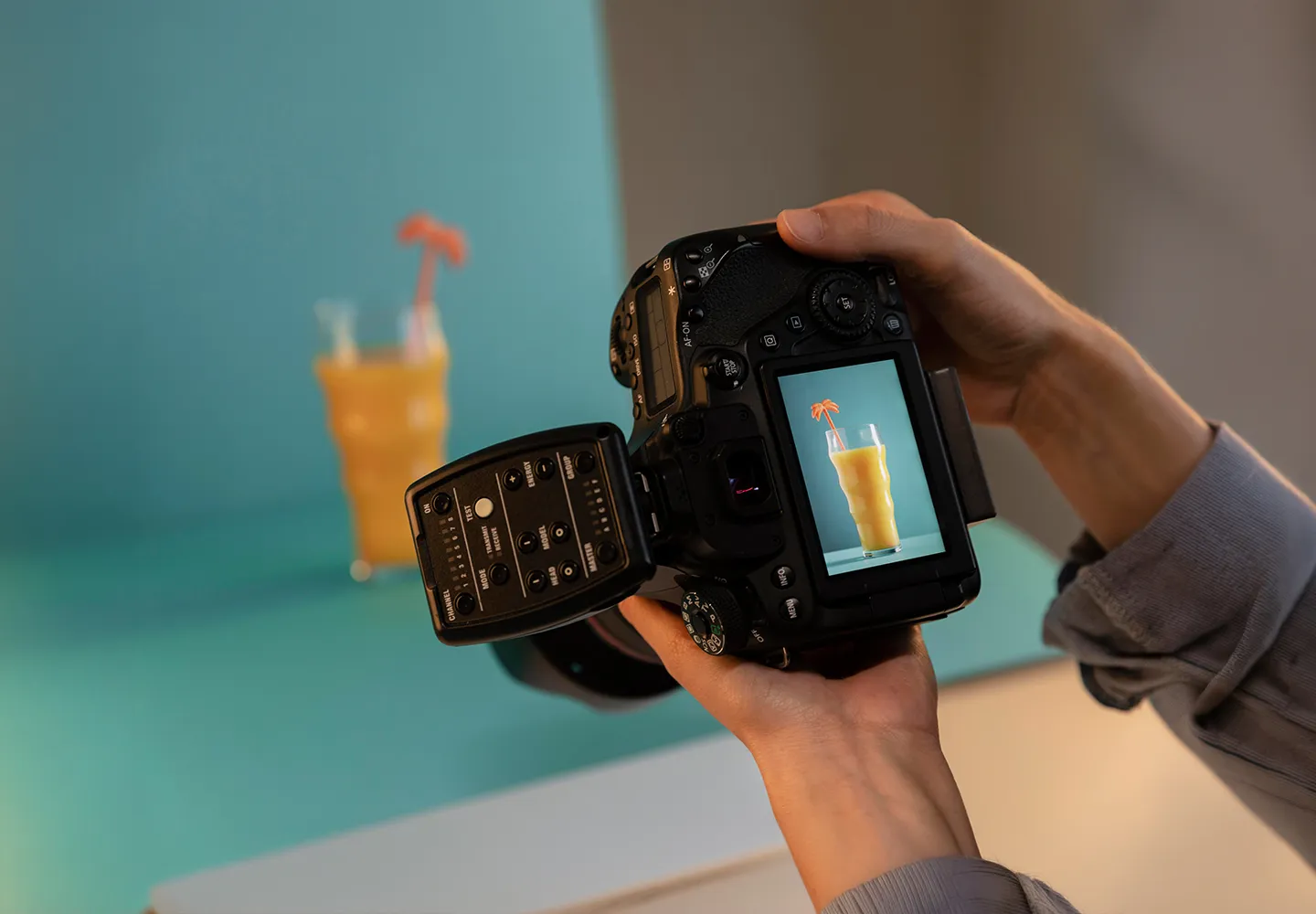 Photographer reviewing a food and beverage shot on a camera screen